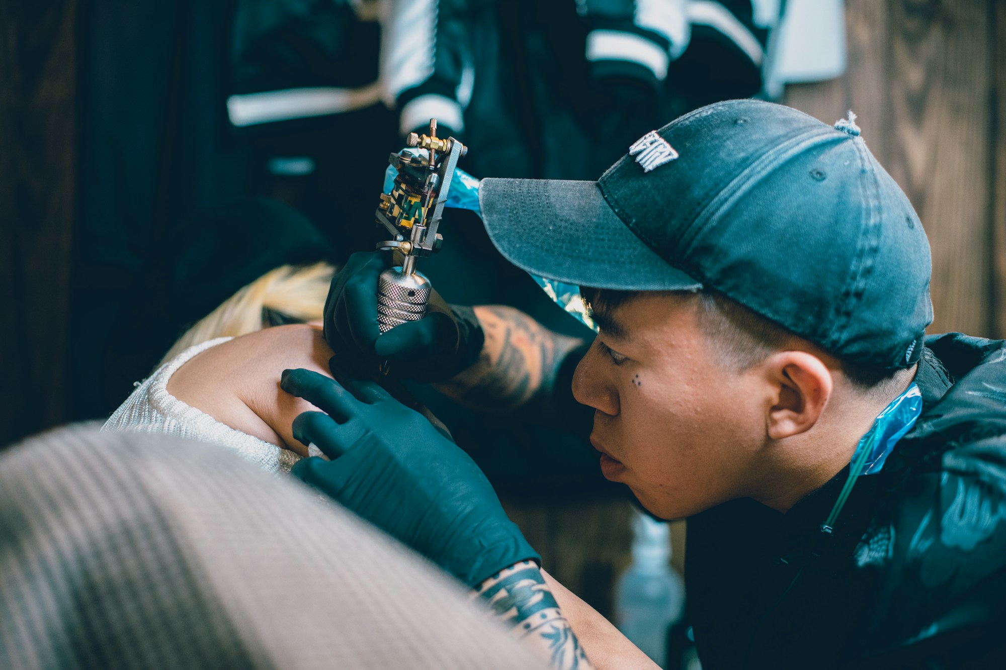 Máquina rotativa de tatuar trabajando una pieza en el brazo de una persona
